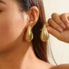Funky gold plated artificial stone earrings in golden color