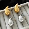 Flat lay of funky artificial stone earrings in golden and silver