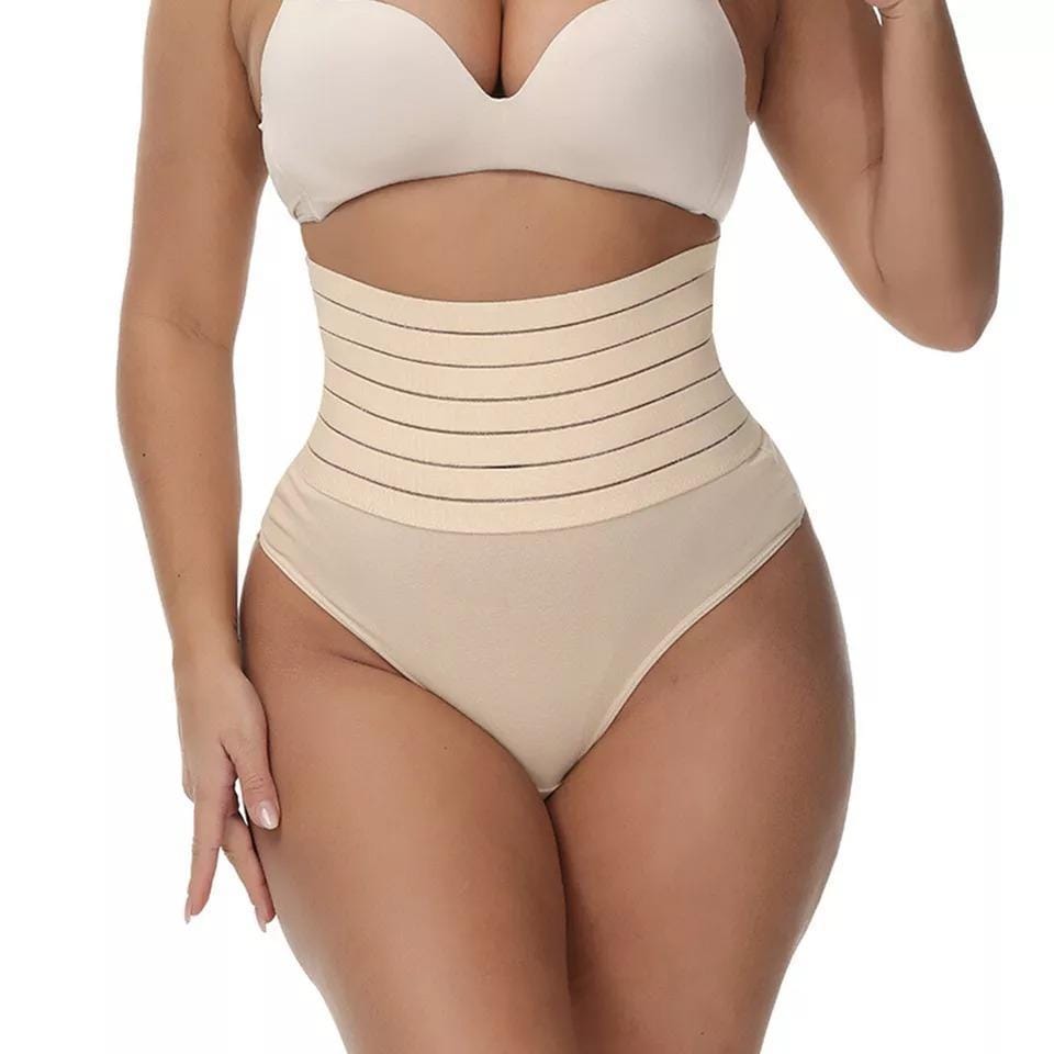 Model wearing panty shaper tights under dress