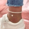 Model wearing silver plated pearl anklet pair