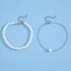 Close-up of pearl stones on silver anklet chain