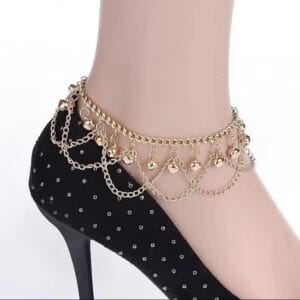 Model wearing bell gold plated anklet with traditional dress