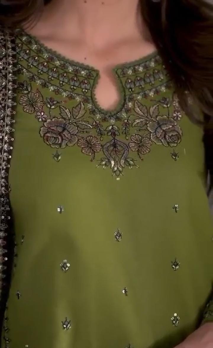 Close-up of embroidery on linen shirt and trouser
