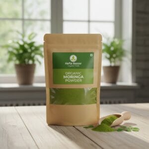 Green moringa powder in wooden spoon – natural detox supplement