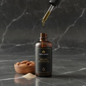 Almond oil in glass bottle with nuts – natural beauty oil