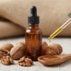 Walnut oil bottle with fresh walnuts – cold pressed natural oil
